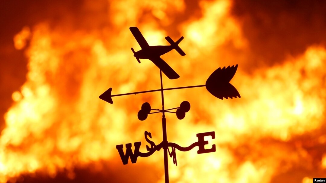 FILE - A weather vane is pictured on a ranch during the Creek Fire in the San Fernando Valley north of Los Angeles, in Sylmar, California, Dec. 5, 2017.