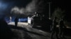 (FILE) Israeli soldiers walk near a military vehicle after returning from Lebanon in northern Israel, December 11, 2024.