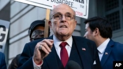 FILE - Former mayor of New York Rudy Giuliani speaks during a news conference outside the federal courthouse in Washington, on Dec. 15, 2023. Giuliani has filed for bankruptcy, days after being ordered to pay $148 million in a defamation lawsuit.