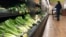 FILE - Romaine lettuce sits on the shelves as a shopper walks through the produce area of an Albertsons market in Simi Valley, Calif., Nov. 20, 2018.