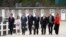 Participants of a G-7 ministerial meeting walk to have a group photo taken on the second day of their talks, in Dinard, France, April 6, 2019.