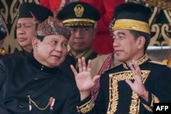 Indonesian President Joko Widodo, right, talks to President-elect Prabowo Subianto following a flag-raising ceremony marking Indonesia's 79th Independence Day at the presidential palace in the future capital, Nusantara, on Aug. 17, 2024.