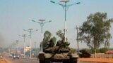 FILE - A military tank patrols along one of the main roads in the South Sudanese capital Juba, Dec. 16, 2013. Three deadly road attacks occurred in South Sudan this week, leaving 10 people dead. 