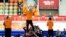 Gold medalist Michel Mulder from the Netherlands jumps in celebration, flanked by Silver medalist Jan Smeekens, right, and bronze medalist Ronald Mulder during the flower ceremony for the men's 500-meter speed skating race at the Adler Arena Skating Cente