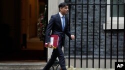 Britain's Prime Minister Rishi Sunak leaves 10 Downing Street to go to the House of Commons for his weekly Prime Minister's Questions in London, Wednesday, Dec. 13, 2023.