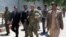 U.S. Army General John Nicholson, commander of Resolute Support forces and U.S. forces in Afghanistan, center, walks with Afghan officials during an official visit in Farah province, Afghanistan, May 19, 2018. Picture taken May 19, 2018. 
