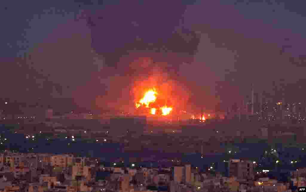 Smoke billows from the site of a refinery fire in the Iranian capital Tehran. A fierce blaze broke out at the refinery in southern Tehran after a liquefied gas line leaked and exploded, the head of the capital&#39;s crisis team said on state television. 
