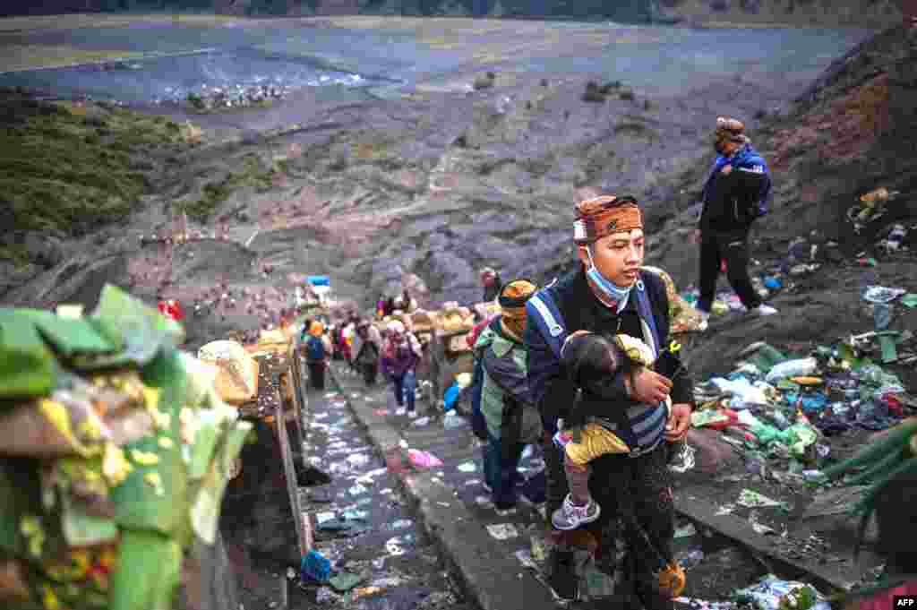 Tengger tribe people make their way to the summit of Mount Bromo volcano to make offerings in Probolinggo, East Java province on July 7, 2020, as part of the Yadnya Kasada Festival.