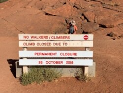 A new permanent closure sign is installed at Uluru, formerly known as Ayers Rock near Yulara, Australia, the day before a permanent ban on climbing the monolith takes effect, Oct. 25, 2019.