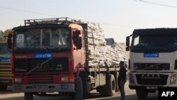 FILE - Trucks carrying humanitarian aid enter the Gaza Strip via the Rafah crossing with Egypt on December 2, 2023.