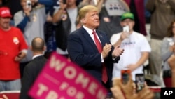 President Donald Trump arrives to speak at a campaign rally, Oct. 4, 2018, in Rochester, Minn. 