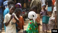 Families in Mpape say they struggle even to keep their children in school and cannot afford to move. (Heather Murdock for VOA)