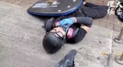 A protester lies with a gunshot wound outside Cheung Hing Kee Shanghai Pan-fried Buns in Hong Kong, Oct. 1, 2019 in this still image taken from a video. (Credit: HKPUSU Press Committee)