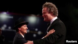 Director Florian Henckel von Donnersmarck, right, and actor Tom Schilling are pictured during the red carpet arrivals for the screening of "Werk Ohne Autor" ("Never Look Away") at the Venice Film Festival, Sept. 4, 2018.