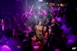 People drink on the dance floor shortly after the reopening, at The Piano Works in Farringdon, in London, July 19, 2021.