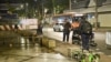 Central Investigation Bureau members stand near the spot where a former Cambodian MP was reportedly shot dead by a man on a motorbike in Bangkok on Jan. 7, 2025. 