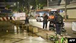 Central Investigation Bureau members stand near the spot where a former Cambodian MP was reportedly shot dead by a man on a motorbike in Bangkok, Thailand, Jan. 7, 2025. 