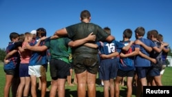 FILE — Students gather after a rugby practice at the Orania CVO School, in the tiny whites-only town of Orania, in the Northern Cape province of South Africa, May 28, 2024. 