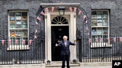 Britain's Prime Minister Boris Johnson talks to journalists outside Downing Street, to mark the 75th anniversary of VE Day, in London, May 8, 2020. 
