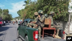 Soldiers patrol a street in Port-au-Prince, Haiti, Dec. 2, 2024.