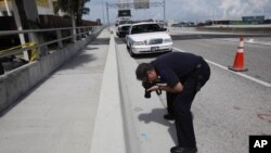 Un investigador fotografía una tarjeta de crédito del caníbal de Miami, Rudy Eugene, encontrada en la escena del crimen, en Miami.