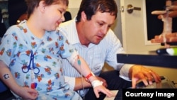 MusicianCorps founder Kiff Gallagher makes music with a patient at a San Francisco children's hospital. (Courtesy MusicianCorps) 