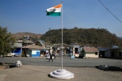 An Indian national flag flies next to an immigration check post on the India-Myanmar border in Zokhawthar village in Champhai district of India's northeastern state of Mizoram, March 16, 2021.