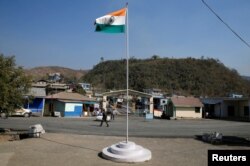 An Indian national flag flies next to an immigration check post on the India-Myanmar border in Zokhawthar village in Champhai district of India's northeastern state of Mizoram, March 16, 2021.