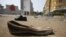 Abandoned shoes litter a street in Plateau district where a stampede occurred after a New Year's Eve fireworks display, Abidjan, Jan. 1, 2013.