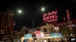 Two men walk past the El Cortez hotel-casino in downtown Las Vegas, Wednesday, Nov. 11, 2020. (AP Photo/Wong Maye-E)