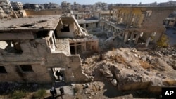 Syrian citizens check the destroyed Jobar Synagogue, also known as Eliyahu Hanavi, in Jobar neighborhood, in Damascus, Syria, Dec. 25, 2024. 