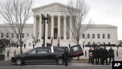 The body of Justice Antonin Scalia arrives at the Supreme Court in Washington, Feb. 19, 2016. Thousands of mourners will pay their respects to him Friday in the court building's Great Hall.