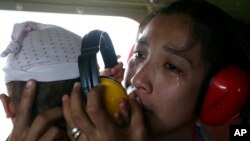 A mother cries in relief upon boarding a Philippine Air Force helicopter in Guiuan township, Nov. 11, 2013.