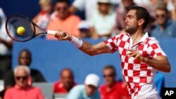Marin Cilic of Croatia returns a shot to Sam Querrey of the United State during their Davis Cup semifinal singles match in Zadar, Croatia, Sept. 16, 2018. 