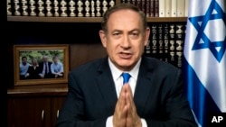 Israeli Prime Minister Benjamin Netanyahu is projected on a screen in Washington as he speaks to attendees of the AIPAC Policy Conference 2017 via satellite from Israel, March 27, 2017, in Washington. 