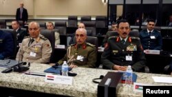 From left, Egypt Lieutenant General Mahmoud Hegazy, Iraq General Babakir Zebari and Jordan General Mashal Al-Zaben listen attend a meeting with more than 20 foreign defense chiefs to discuss U.S.-led coalition efforts in the campaign against Islamic Stat