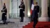 FILE - French President Emmanuel Macron climbs the stairs outside the Elysee Palace in Paris, France, Jan. 23, 2019.