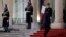FILE - French President Emmanuel Macron climbs the stairs outside the Elysee Palace in Paris, France, Jan. 23, 2019.
