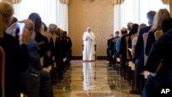 Pope Francis speaks to alumni of Jesuit schools in Europe, who were in Rome for a conference on refugees, at the Vatican, Sept. 17, 2016.