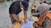 FILE - A Libyan man registers to vote inside a polling station in Tripoli, Nov. 8, 2021. 