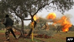Members of Syria's opposition National Liberation Front fire heavy artillery guns at government forces in the village of Talhiyeh near the town Taftanaz in northeastern Idlib province, Feb. 28, 2020. 