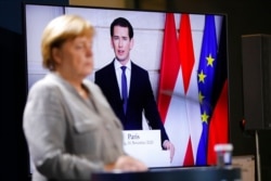 FILE - German Chancellor Angela Merkel listens to Austrian Chancellor Sebastian Kurz during a virtual news conference at the chancellery in Berlin, Germany, Nov. 10, 2020.