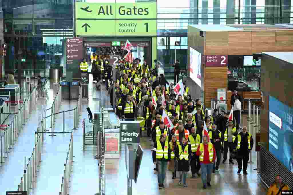 Airport workers demonstrate during a 24-hour strike at Berlin airport called by the German trade union Verdi over a wage dispute in Berlin.