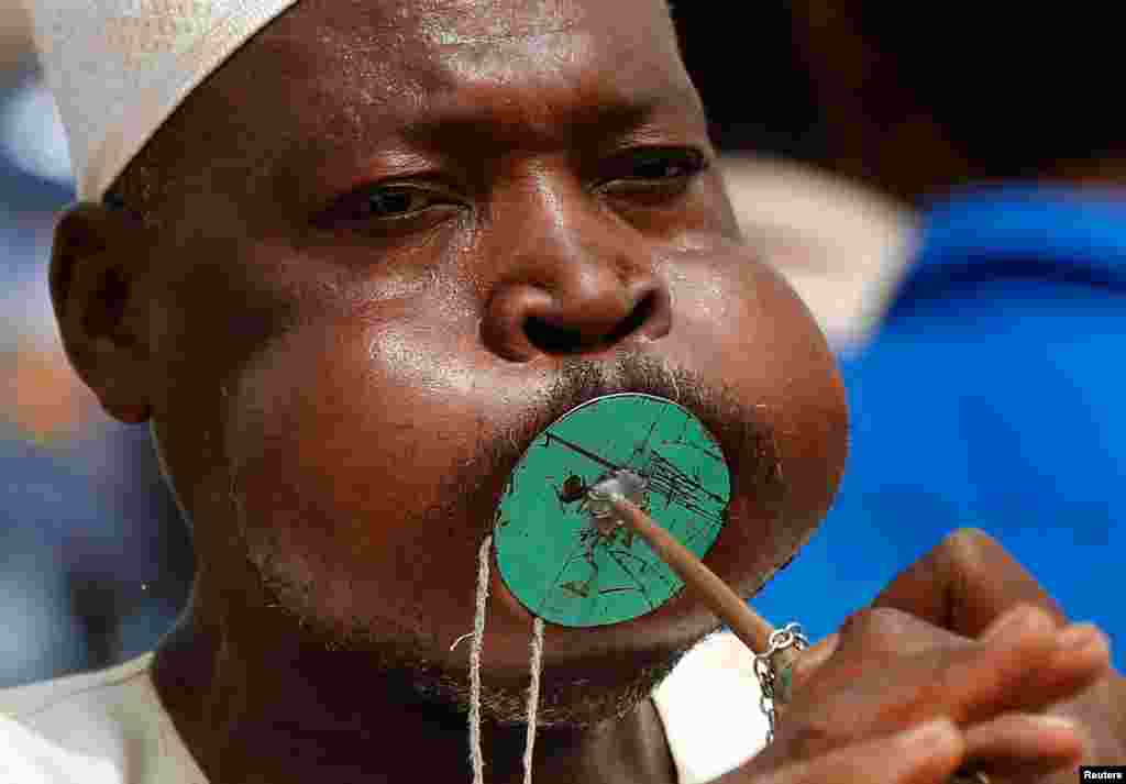 A Sudanese supporter of Gen. Mohammed Hamdan Dagalo, the deputy head of the military council, better known as Hemedti, blows a horn during a military-backed rally, in Mayo district, south of Khartoum, June 29, 2019.