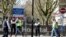 Police officers and building workers are seen outside St Thomas' Hospital in London after British Prime Minister Boris Johnson was admitted with persistent coronavirus (COVID-19) symptoms, London, April 6, 2020. 