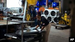 FILE: Sheet metal worker Carey Mercer assembles ductwork at Contractors Sheet Metal on Tuesday, Aug. 3, 2021, in New York.