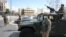 Jordanian army members stand guard outside a hotel that was transformed into a quarantine station amid concerns over the coronavirus (COVID-19) in Amman, March 17, 2020. 
