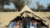 Afghan students attend a school class under a tent in Jalalabad, capital of Nangarhar province, Afghanistan, Dec. 16, 2015. 