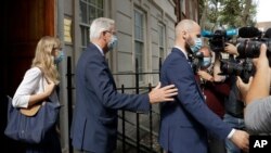 EU Chief negotiator Michel Barnier, centre, is led by security as he leaves the Europa house in London, Sept. 10, 2020.