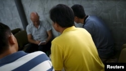 FILE - Chinese dissidents, who asked not to be identified, speak during an interview with Reuters in Bangkok, Feb. 2, 2016. 